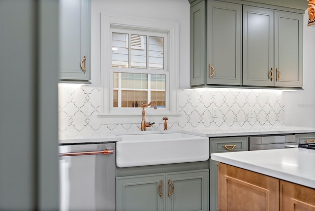 kitchen featuring tasteful backsplash, sink, and stainless steel dishwasher