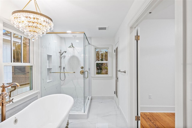 bathroom featuring independent shower and bath and a chandelier