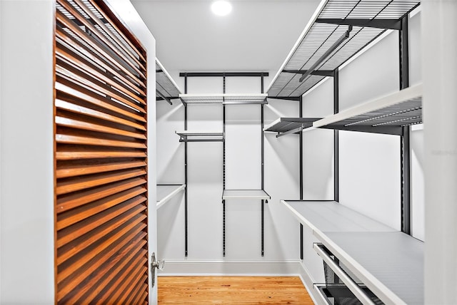 spacious closet with light hardwood / wood-style floors