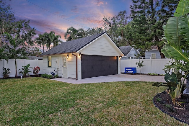 view of front of property with an outbuilding, a garage, and a lawn