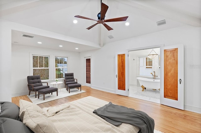 bedroom with high vaulted ceiling and light hardwood / wood-style flooring