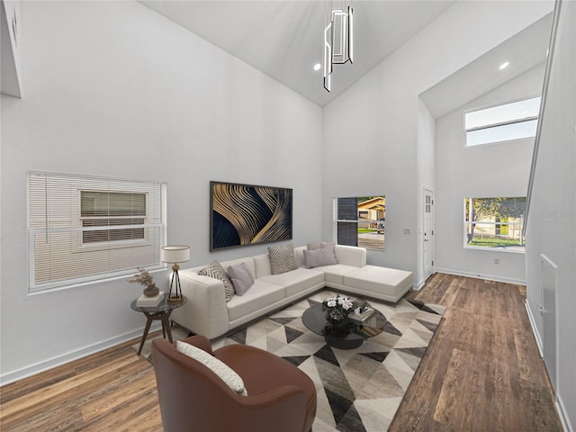 living room with high vaulted ceiling and hardwood / wood-style flooring