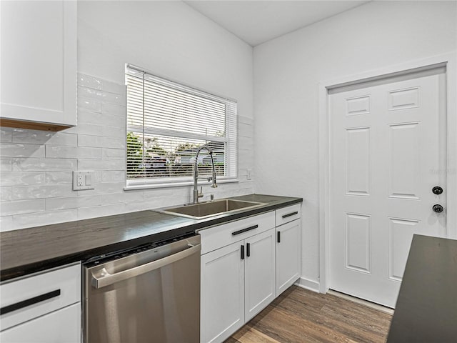 kitchen with white cabinetry, dishwasher, sink, dark hardwood / wood-style flooring, and backsplash