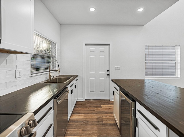 kitchen with white cabinetry, stainless steel appliances, tasteful backsplash, wine cooler, and dark hardwood / wood-style floors