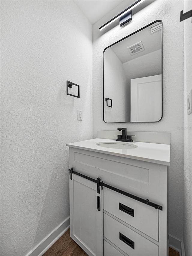 bathroom with vanity and hardwood / wood-style flooring