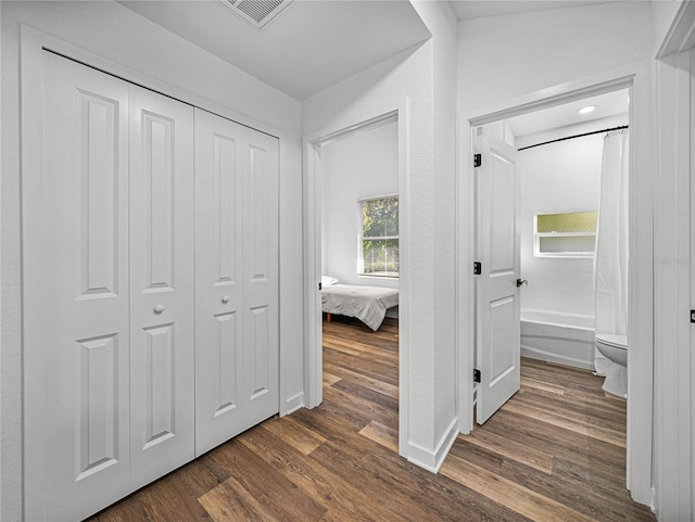 hall with dark hardwood / wood-style flooring and vaulted ceiling