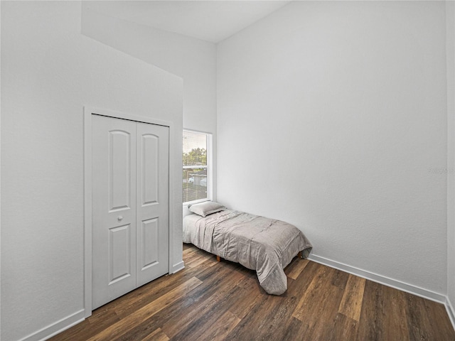 bedroom featuring a closet and dark wood-type flooring