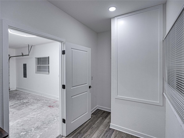 hall with electric panel and dark wood-type flooring