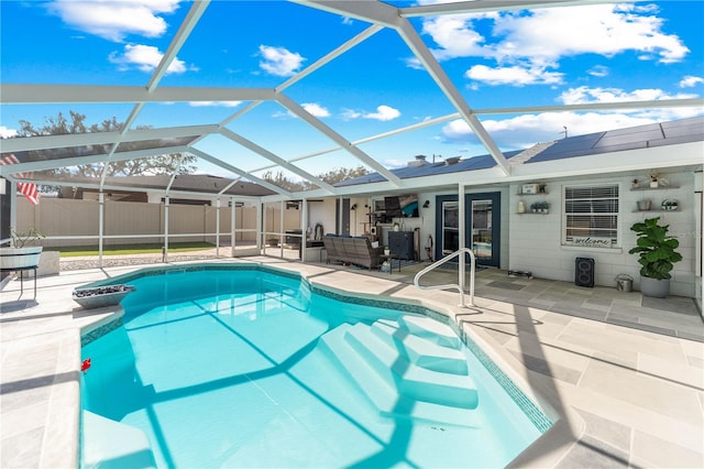 view of swimming pool featuring a lanai and a patio