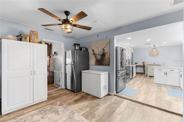 kitchen featuring white cabinetry, light hardwood / wood-style flooring, ceiling fan, and stainless steel appliances