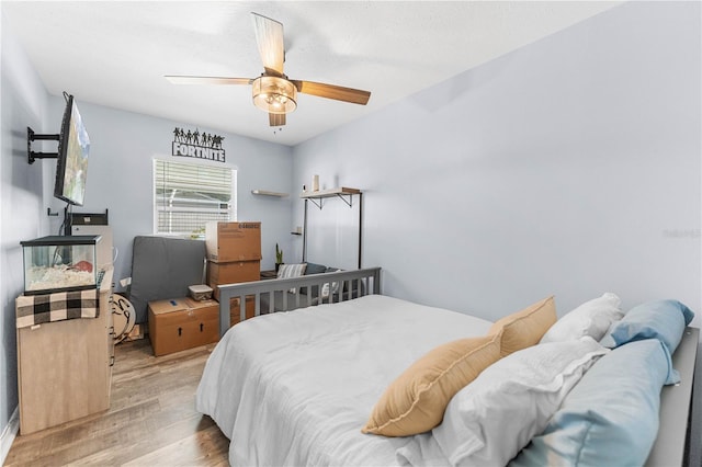 bedroom with light hardwood / wood-style floors and ceiling fan