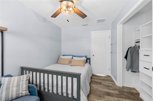 bedroom with dark hardwood / wood-style flooring and ceiling fan