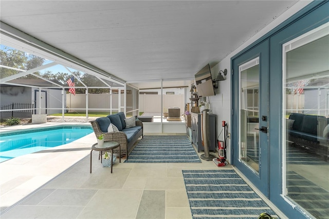 view of swimming pool with glass enclosure, outdoor lounge area, french doors, cooling unit, and a patio