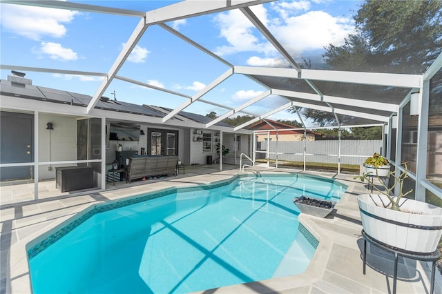 view of swimming pool featuring a lanai, an outdoor living space, and a patio area