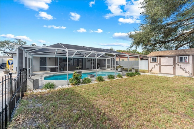 view of pool featuring a shed, a lanai, and a lawn