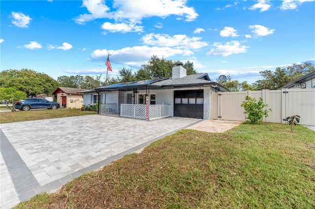 view of front facade with a garage and a front lawn