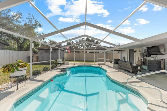 view of swimming pool featuring glass enclosure and a patio area