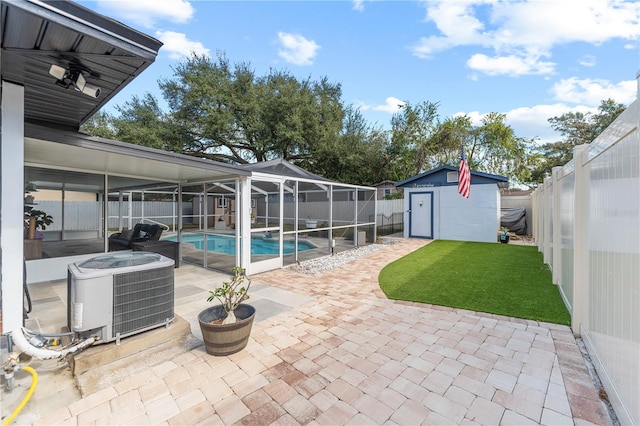 view of pool with a storage unit, a patio area, cooling unit, and a lanai