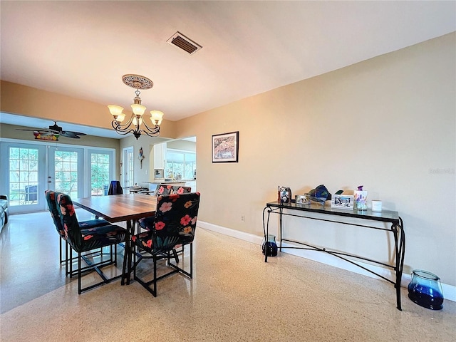 dining room with ceiling fan with notable chandelier and french doors