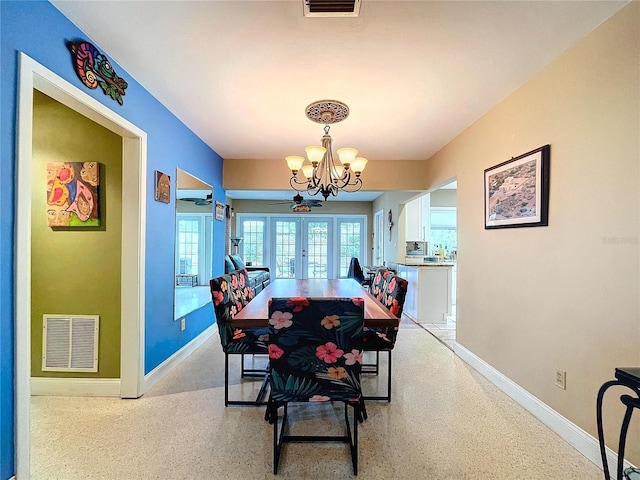 dining room with french doors and a chandelier