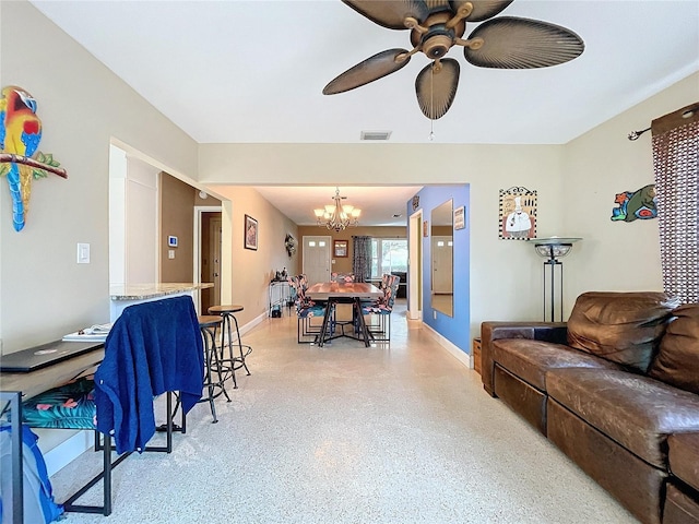 living room with ceiling fan with notable chandelier