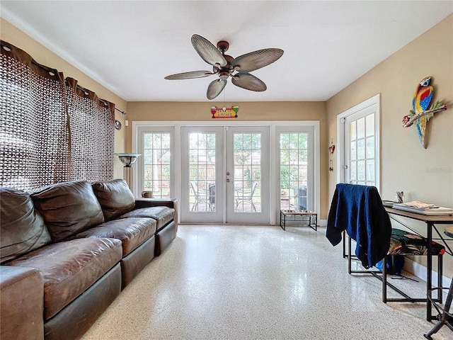 living room with ceiling fan and french doors