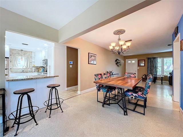 dining room with a notable chandelier