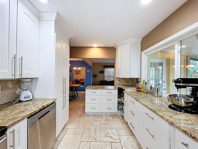 kitchen featuring backsplash, white cabinetry, stainless steel dishwasher, and light stone counters