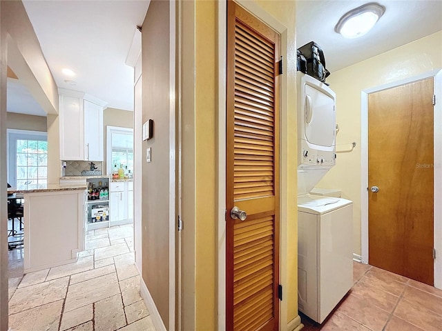 laundry area with stacked washer and dryer