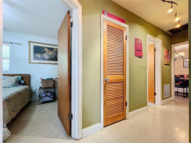 corridor with an inviting chandelier