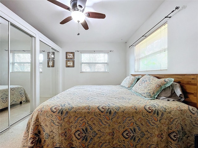 bedroom with multiple closets and ceiling fan