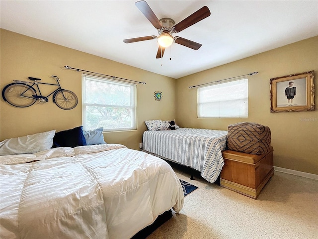 bedroom featuring multiple windows and ceiling fan