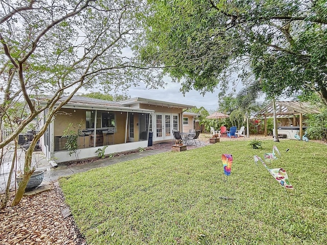 view of yard with a sunroom and a patio