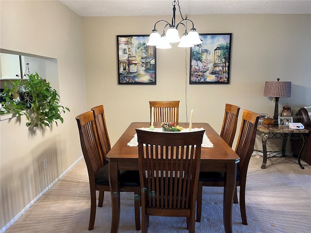 carpeted dining space featuring a notable chandelier and a textured ceiling