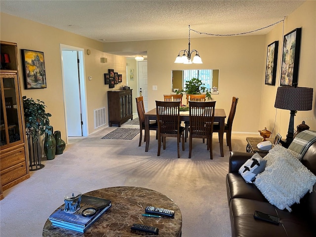 carpeted dining space with a textured ceiling and a notable chandelier