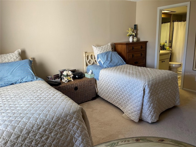 carpeted bedroom with ensuite bath