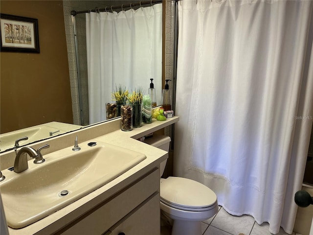 bathroom with tile patterned floors, vanity, toilet, and walk in shower