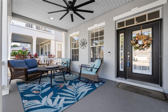 entrance to property featuring covered porch and ceiling fan