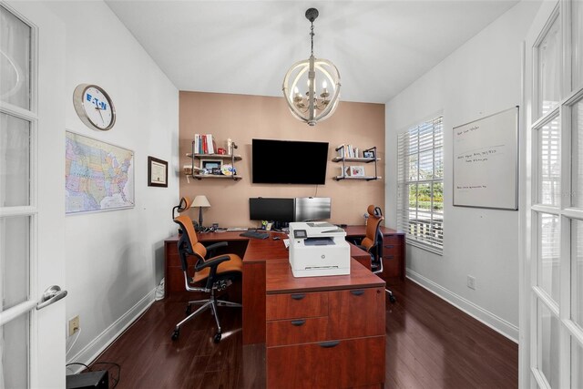 home office with dark hardwood / wood-style flooring and a chandelier