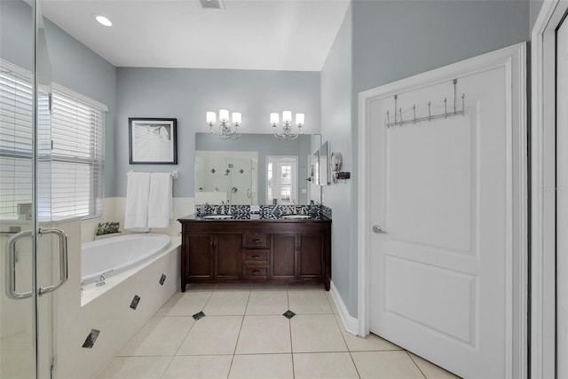 bathroom featuring tile patterned flooring, separate shower and tub, a healthy amount of sunlight, and a chandelier