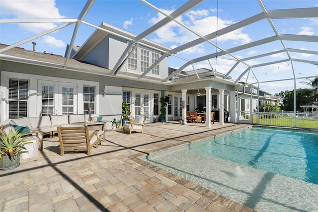 view of swimming pool with french doors, glass enclosure, ceiling fan, an outdoor hangout area, and a patio