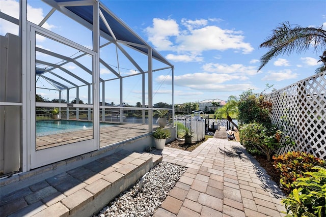 view of patio featuring a lanai