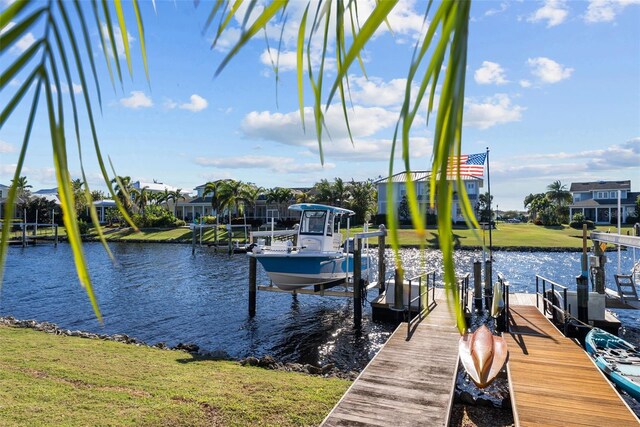 view of dock featuring a yard and a water view