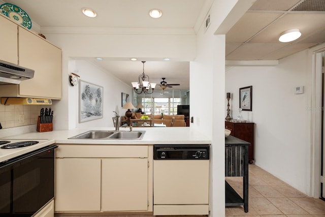 kitchen featuring decorative backsplash, white appliances, sink, light tile patterned floors, and cream cabinetry