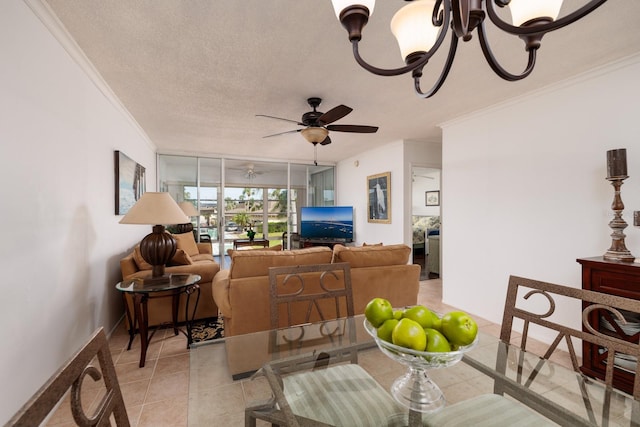 tiled living room with a textured ceiling, ceiling fan with notable chandelier, and crown molding