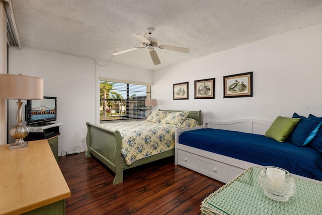 bedroom featuring a textured ceiling, dark hardwood / wood-style flooring, and ceiling fan