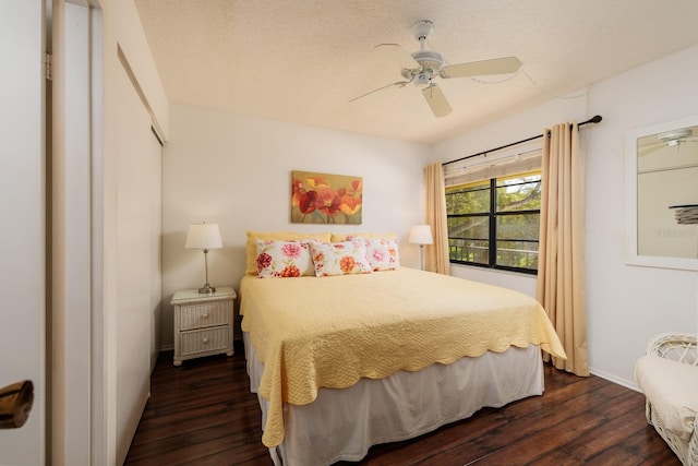 bedroom with a closet, ceiling fan, and dark hardwood / wood-style flooring