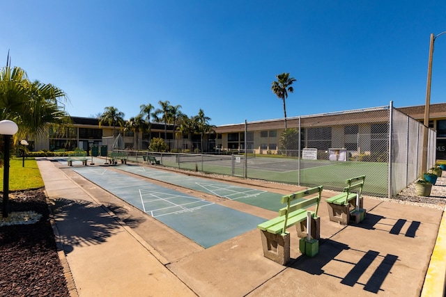 view of property's community featuring tennis court