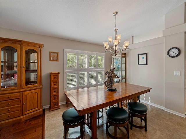 tiled dining area featuring a notable chandelier