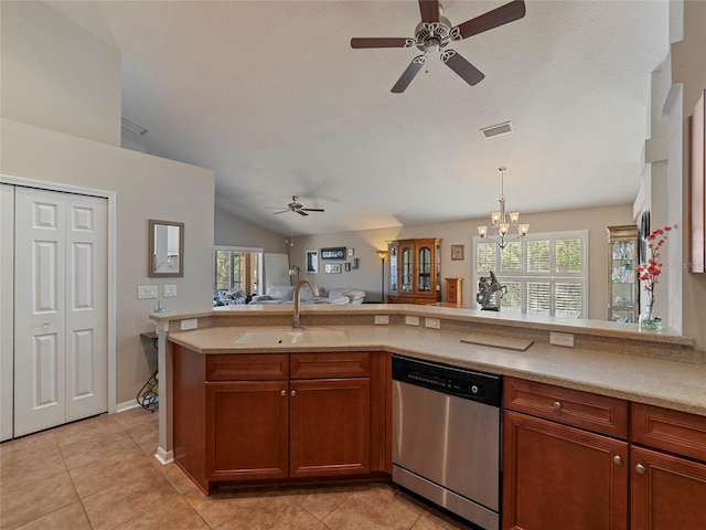 kitchen featuring a wealth of natural light, lofted ceiling, sink, stainless steel dishwasher, and light tile patterned floors